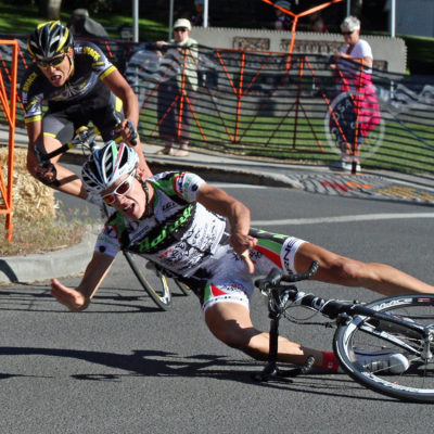 A rider crashes while rounding a corner during the criterium of the USA Cycling U23 Road Nationals in downtown Bend, Oregon.